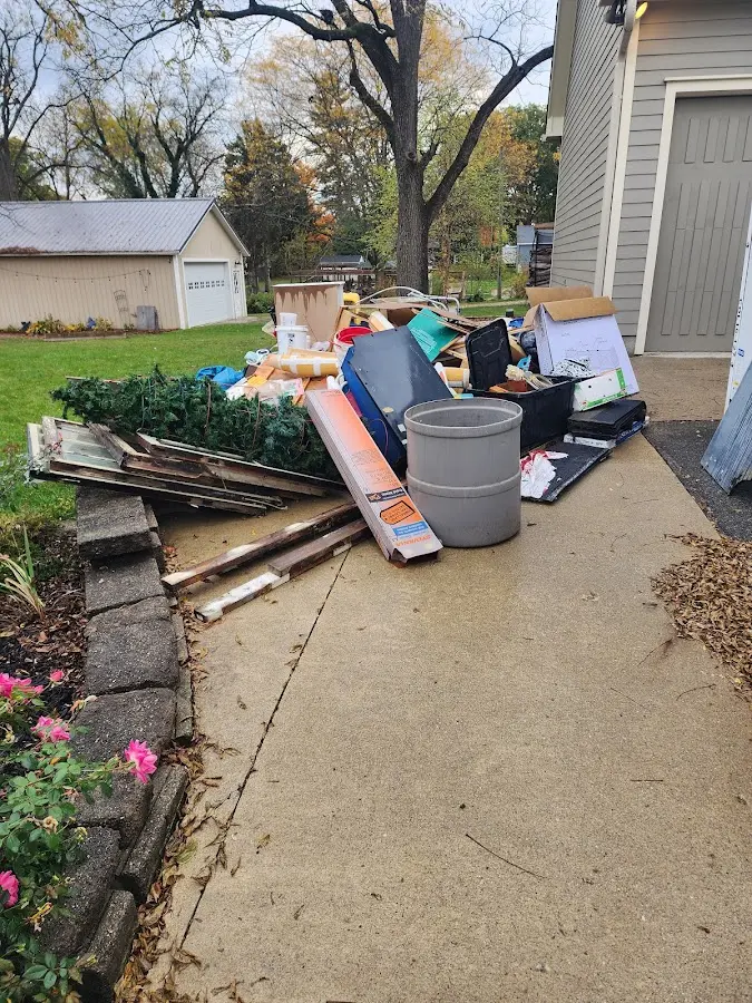 Dumpster being loaded with debris for Estate Cleanout Dumpster Rental in Sugar Grove
